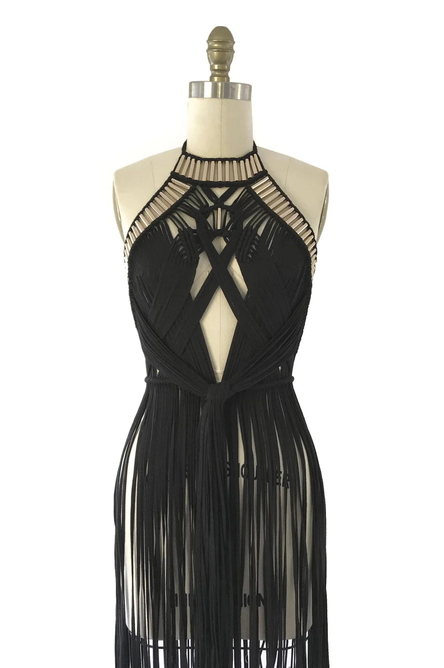 Black fringe dress on a mannequin against a white background