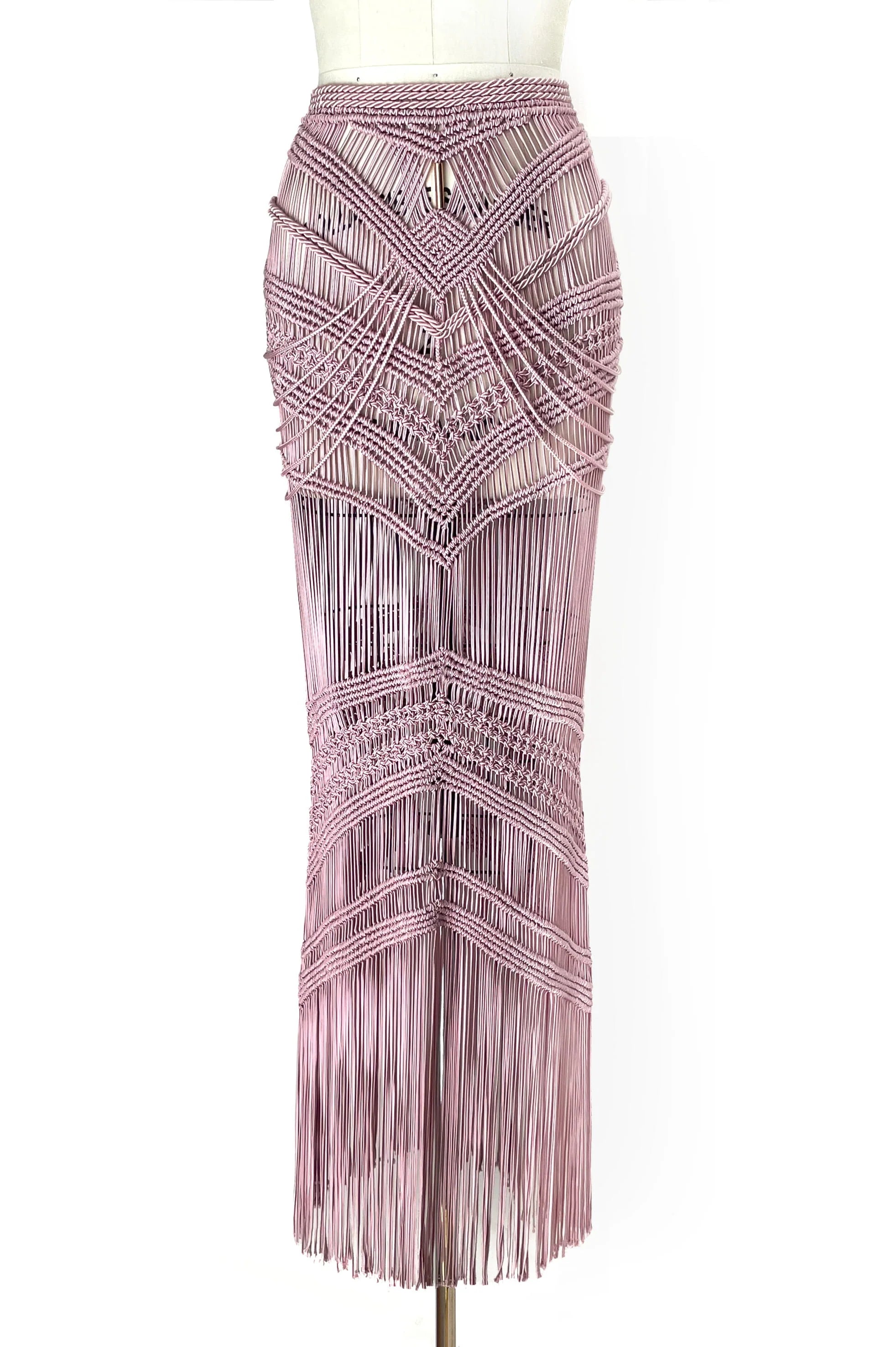 Pink beaded skirt on a mannequin against a white background