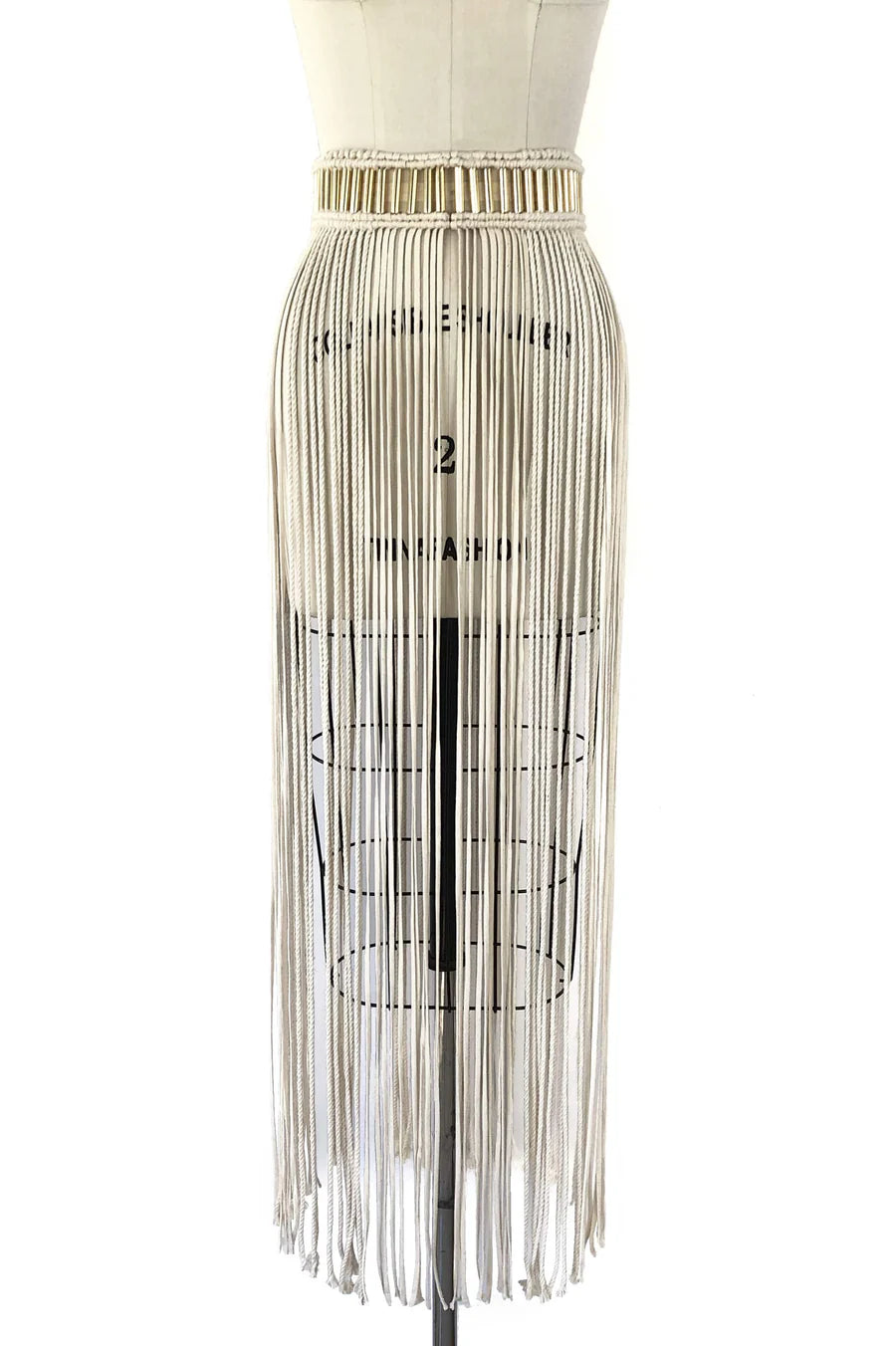 Skirt with fringe on a mannequin against a white background